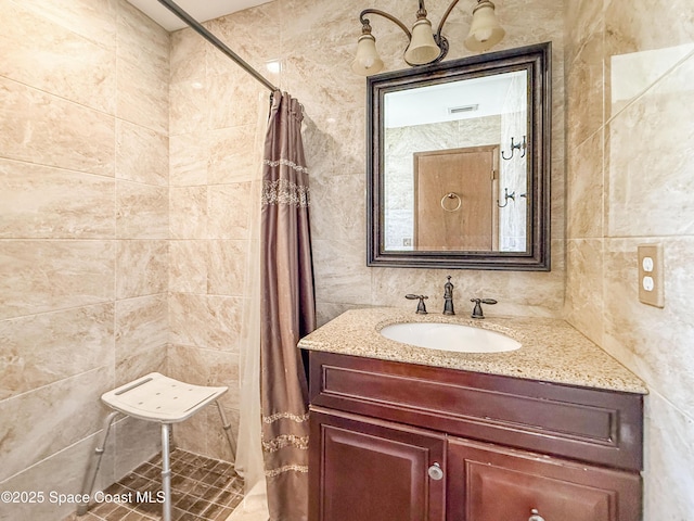 1395 Angler St, Merritt Island, FL 32952 - full bath with tiled shower, vanity, and tile walls