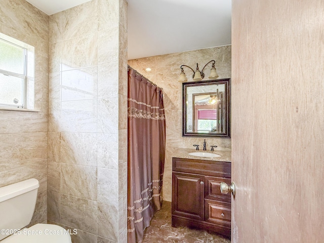 1395 Angler St, Merritt Island, FL 32952 - bathroom featuring toilet, vanity, curtained shower, and tile walls