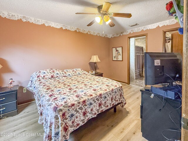 1395 Angler St, Merritt Island, FL 32952 - bedroom featuring light wood-type flooring, a textured ceiling, ceiling fan, and baseboards