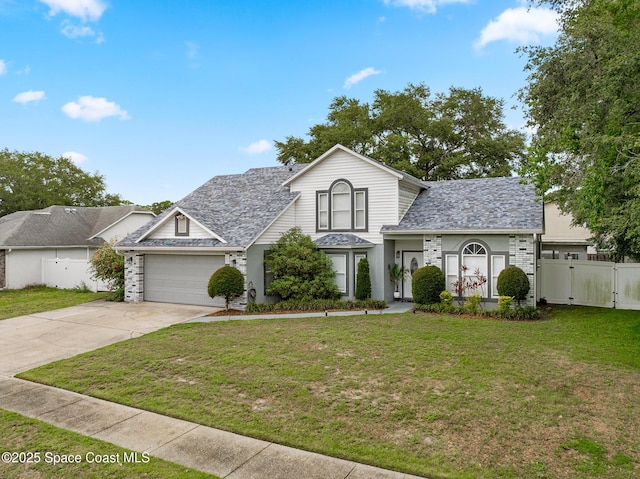 4236 Pondapple Dr, Titusville, FL 32796 - traditional-style home with driveway, an attached garage, and a gate