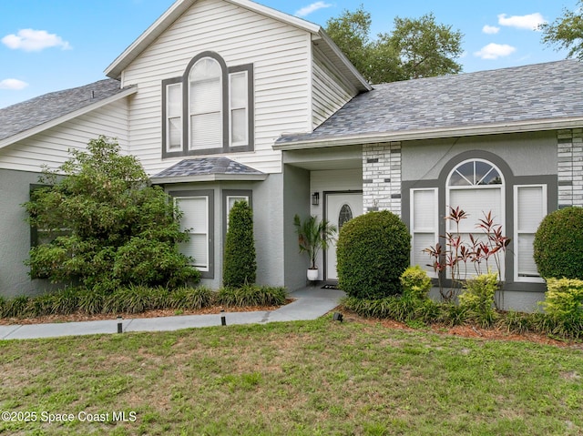 4236 Pondapple Dr, Titusville, FL 32796 - view of front of property with a front yard and a shingled roof