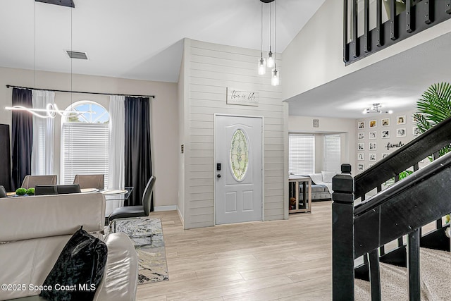 4236 Pondapple Dr, Titusville, FL 32796 - foyer featuring a chandelier, wood finished floors, and stairway