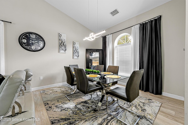 4236 Pondapple Dr, Titusville, FL 32796 - dining space featuring baseboards, wood finished floors, and high vaulted ceiling