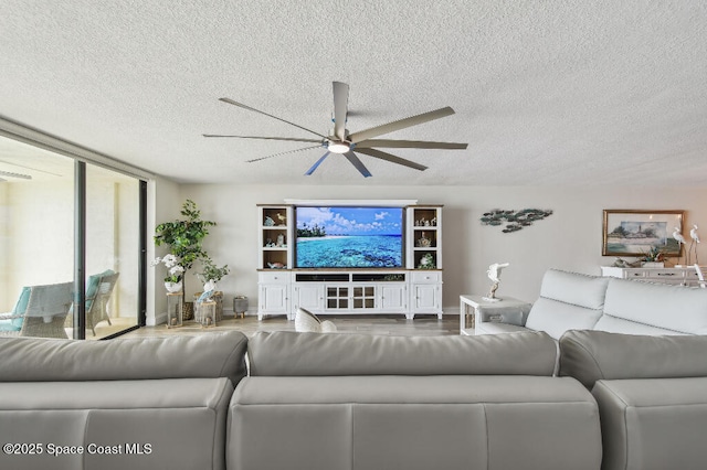 3221 S Atlantic Ave Unit 703, Cocoa Beach, FL 32931 - living room featuring a ceiling fan, a textured ceiling, and wood finished floors
