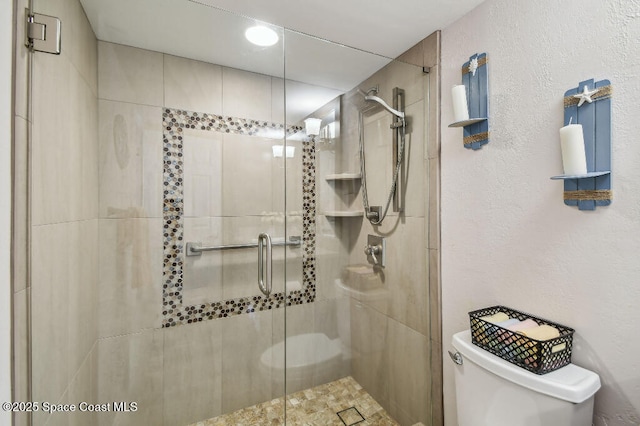 3221 S Atlantic Ave Unit 703, Cocoa Beach, FL 32931 - bathroom featuring toilet and a shower stall