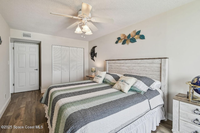 3221 S Atlantic Ave Unit 703, Cocoa Beach, FL 32931 - bedroom featuring a closet, wood finished floors, baseboards, a ceiling fan, and a textured ceiling