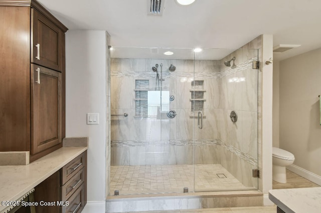 3221 S Atlantic Ave Unit 703, Cocoa Beach, FL 32931 - bathroom with vanity, baseboards, a stall shower, and toilet