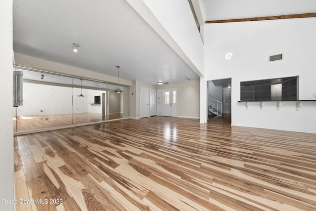 105 Osprey Ct, Melbourne, FL 32940 - unfurnished living room with wood finished floors and stairs
