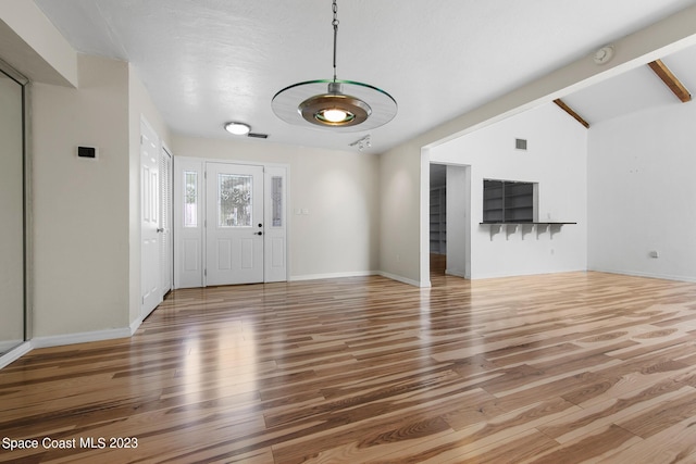 105 Osprey Ct, Melbourne, FL 32940 - entryway featuring wood finished floors, baseboards, and vaulted ceiling