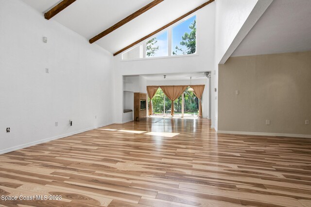 105 Osprey Ct, Melbourne, FL 32940 - unfurnished living room featuring high vaulted ceiling, beam ceiling, light wood-style flooring, and baseboards