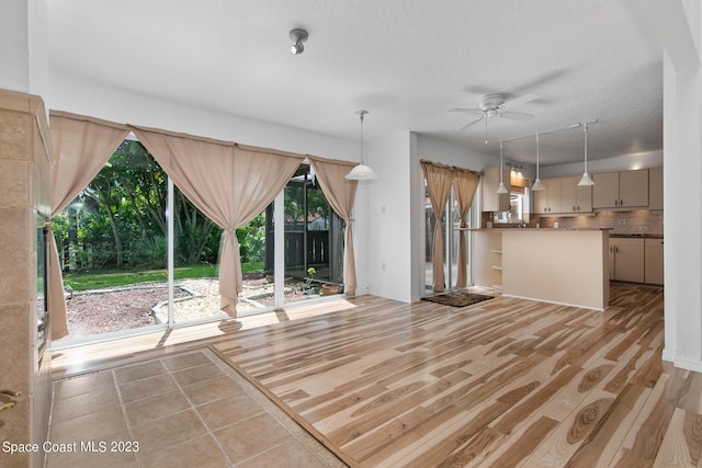 105 Osprey Ct, Melbourne, FL 32940 - unfurnished living room with ceiling fan and light wood-type flooring