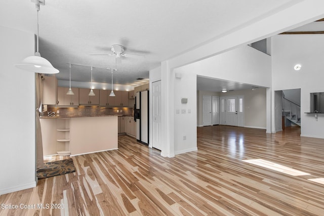 105 Osprey Ct, Melbourne, FL 32940 - kitchen featuring freestanding refrigerator, open floor plan, ceiling fan, light wood-style flooring, and tasteful backsplash