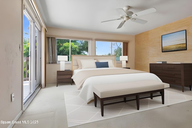 105 Osprey Ct, Melbourne, FL 32940 - bedroom featuring an accent wall, baseboards, access to outside, a ceiling fan, and light carpet