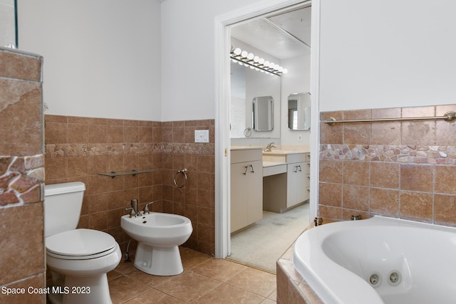 105 Osprey Ct, Melbourne, FL 32940 - bathroom featuring tile walls, a jetted tub, toilet, vanity, and tile patterned floors