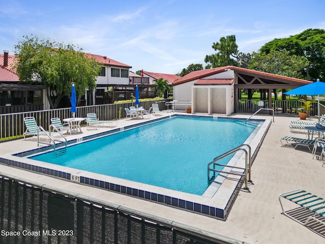105 Osprey Ct, Melbourne, FL 32940 - community pool featuring a patio
