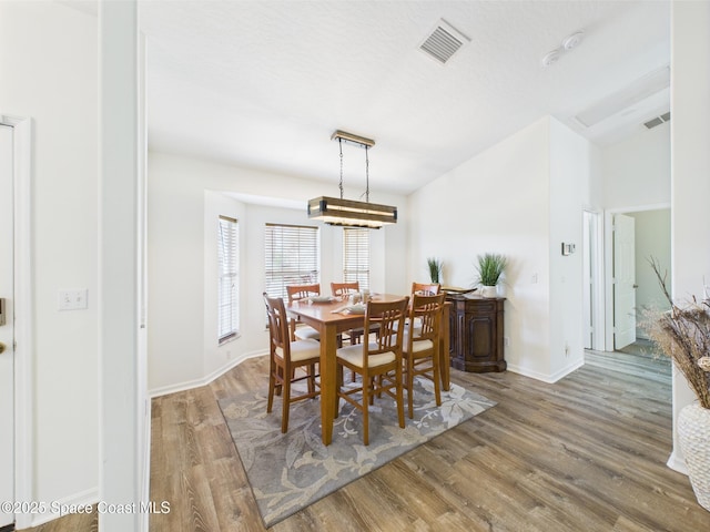 187 S Wimbrow Dr, Sebastian, FL 32958 - dining space featuring wood finished floors, baseboards, and lofted ceiling