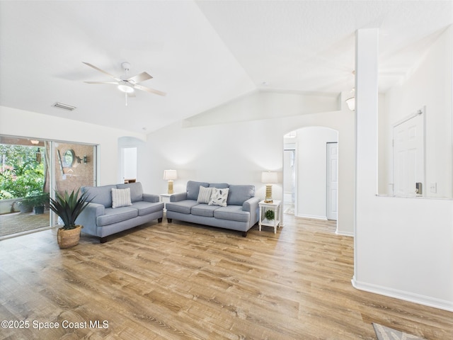 187 S Wimbrow Dr, Sebastian, FL 32958 - living area featuring arched walkways, vaulted ceiling, ceiling fan, light wood finished floors, and baseboards