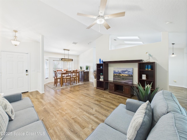 187 S Wimbrow Dr, Sebastian, FL 32958 - living room with vaulted ceiling, light wood finished floors, a ceiling fan, and baseboards