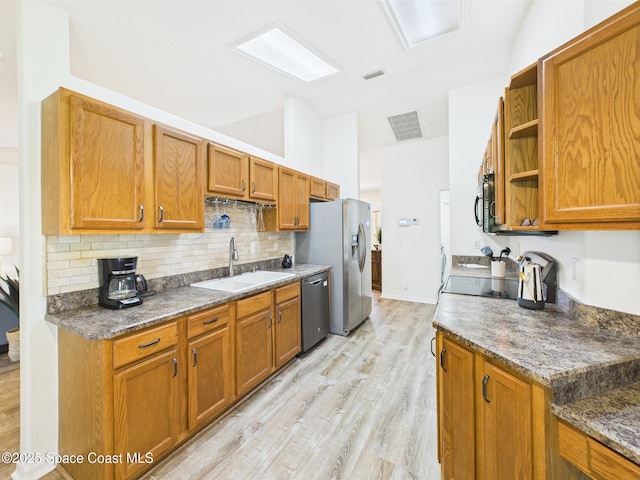 187 S Wimbrow Dr, Sebastian, FL 32958 - kitchen featuring a sink, dishwashing machine, open shelves, decorative backsplash, and lofted ceiling