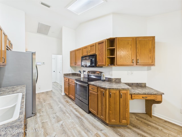 187 S Wimbrow Dr, Sebastian, FL 32958 - kitchen with appliances with stainless steel finishes, light wood finished floors, open shelves, lofted ceiling, and brown cabinets