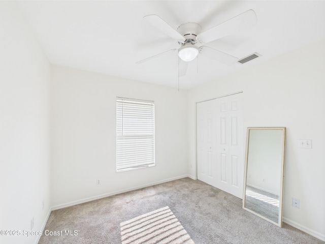 187 S Wimbrow Dr, Sebastian, FL 32958 - unfurnished bedroom featuring carpet flooring, a closet, baseboards, and a ceiling fan