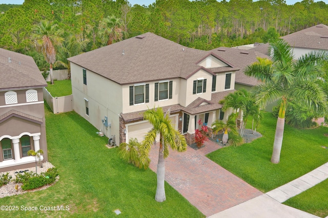 1403 Musgrass Cir, West Melbourne, FL 32904 - view of front of property with stucco siding, decorative driveway, a shingled roof, and a garage