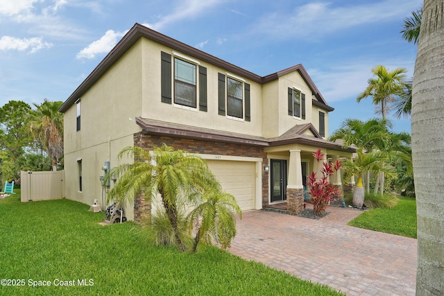1403 Musgrass Cir, West Melbourne, FL 32904 - view of front facade featuring stucco siding, an attached garage, decorative driveway, and a porch