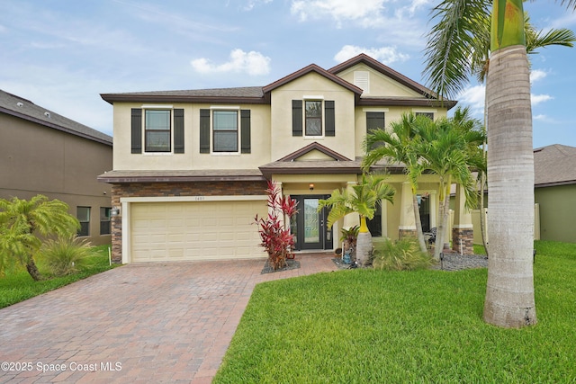 1403 Musgrass Cir, West Melbourne, FL 32904 - view of front of house featuring a garage, stucco siding, decorative driveway, and a front yard