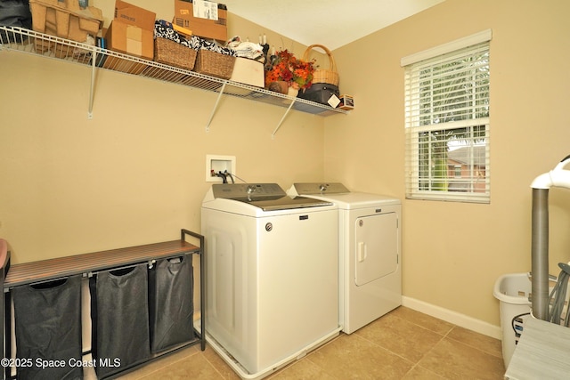 1403 Musgrass Cir, West Melbourne, FL 32904 - laundry room featuring washer and dryer, light tile patterned floors, and baseboards