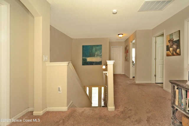 1403 Musgrass Cir, West Melbourne, FL 32904 - hallway with an upstairs landing, carpet flooring, and baseboards
