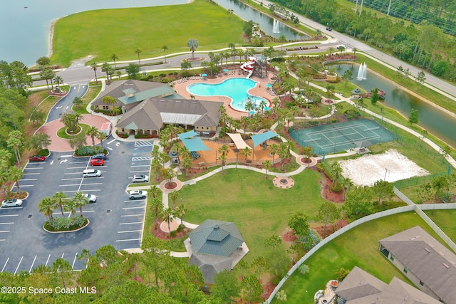 1403 Musgrass Cir, West Melbourne, FL 32904 - drone / aerial view of a pool area and a large body of water