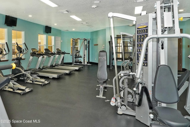 1403 Musgrass Cir, West Melbourne, FL 32904 - exercise room with a textured ceiling