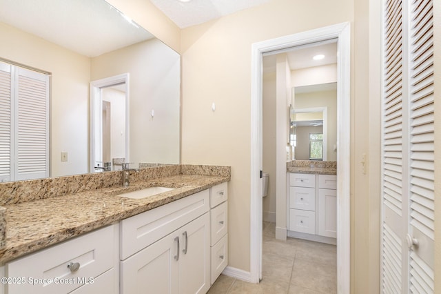 3137 Village Park Dr, Melbourne, FL 32934 - bathroom featuring a closet, vanity, tile patterned floors, and baseboards