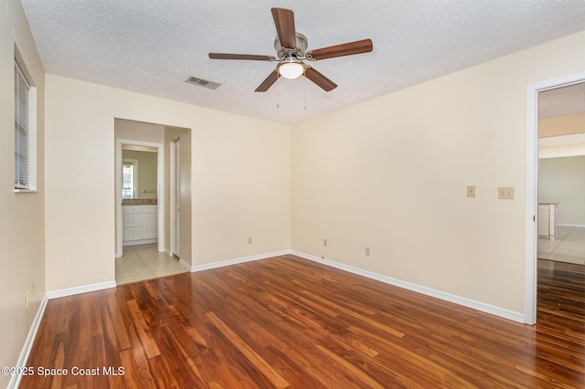 3137 Village Park Dr, Melbourne, FL 32934 - unfurnished room with wood finished floors, ceiling fan, a textured ceiling, and baseboards
