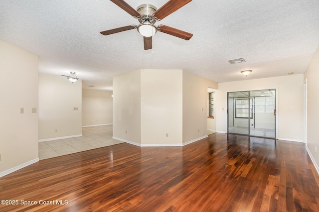 3137 Village Park Dr, Melbourne, FL 32934 - spare room featuring hardwood / wood-style flooring, a textured ceiling, a ceiling fan, and baseboards