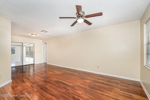 3137 Village Park Dr, Melbourne, FL 32934 - unfurnished room featuring wood finished floors, ceiling fan, baseboards, and a textured ceiling