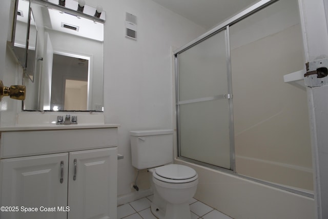 217 San Juan Cir, Melbourne, FL 32935 - bathroom with toilet, tile patterned flooring, vanity, and combined bath / shower with glass door