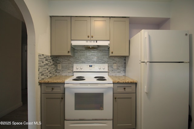 217 San Juan Cir, Melbourne, FL 32935 - kitchen with white appliances, under cabinet range hood, gray cabinets, and backsplash