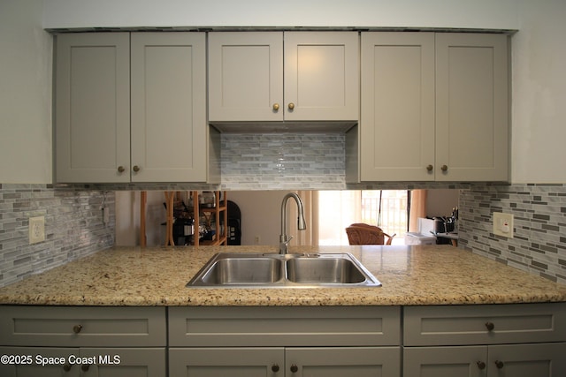 217 San Juan Cir, Melbourne, FL 32935 - kitchen featuring a sink, gray cabinets, and decorative backsplash