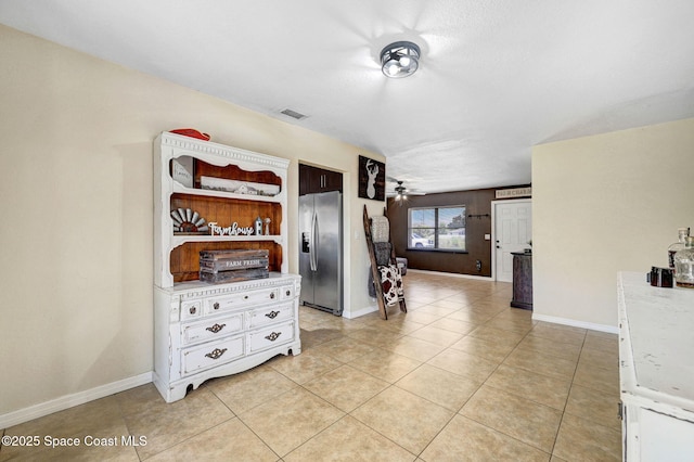 946 Stage St SE, Palm Bay, FL 32909 - spare room featuring light tile patterned floors, ceiling fan, and baseboards