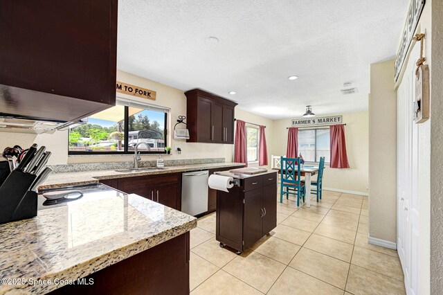 946 Stage St SE, Palm Bay, FL 32909 - kitchen featuring appliances with stainless steel finishes, a sink, healthy amount of natural light, a center island, and a textured ceiling