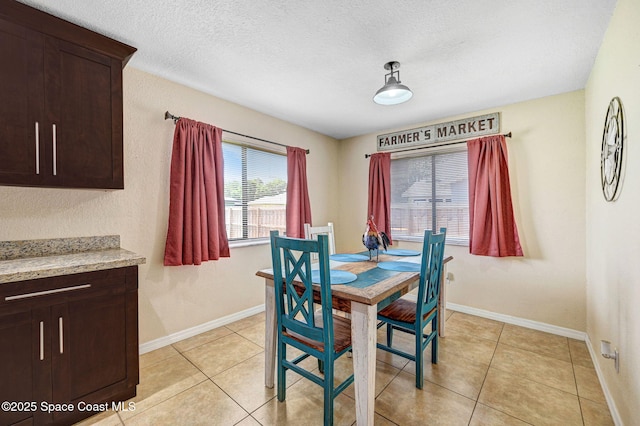 946 Stage St SE, Palm Bay, FL 32909 - dining area featuring light tile patterned floors, baseboards, and a textured ceiling