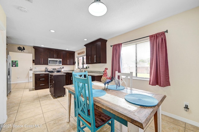 946 Stage St SE, Palm Bay, FL 32909 - dining space with light tile patterned flooring, baseboards, and recessed lighting
