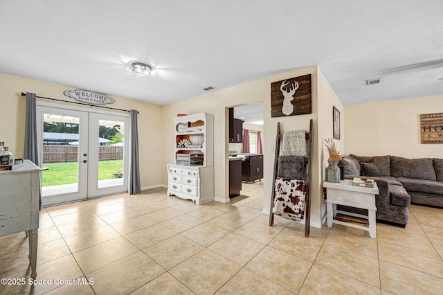 946 Stage St SE, Palm Bay, FL 32909 - living area with french doors, light tile patterned flooring, and baseboards