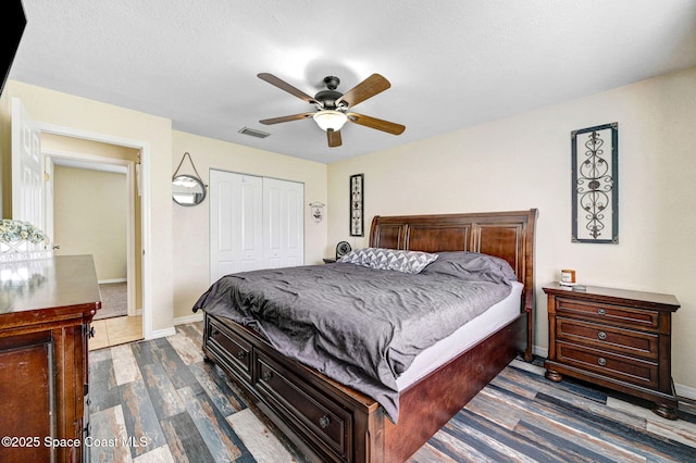 946 Stage St SE, Palm Bay, FL 32909 - bedroom with a closet, wood finished floors, a ceiling fan, and baseboards