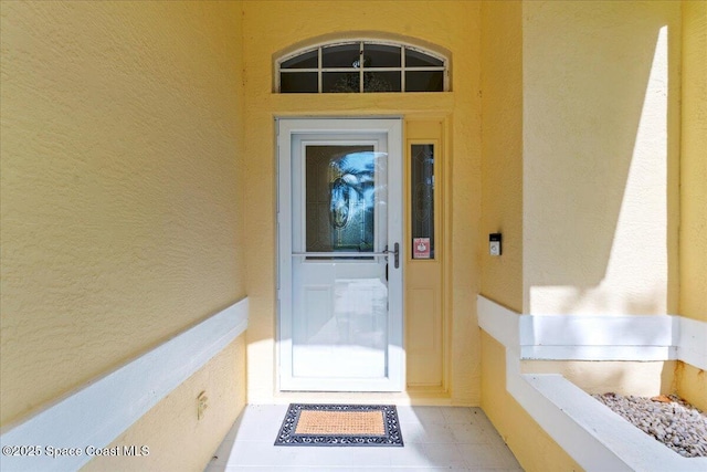 990 Harbor Pines Dr, Merritt Island, FL 32952 - doorway to property featuring stucco siding