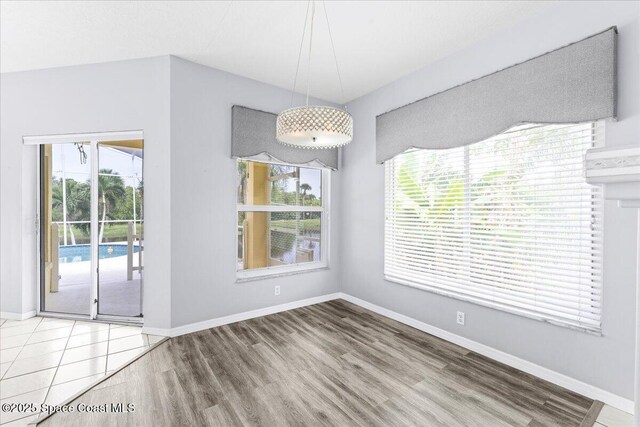 990 Harbor Pines Dr, Merritt Island, FL 32952 - unfurnished dining area featuring wood finished floors and baseboards