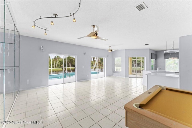 990 Harbor Pines Dr, Merritt Island, FL 32952 - unfurnished living room with a ceiling fan, a sink, light tile patterned floors, a textured ceiling, and billiards table