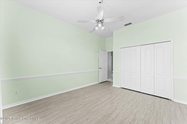 990 Harbor Pines Dr, Merritt Island, FL 32952 - unfurnished bedroom with wood finished floors, baseboards, a closet, and a ceiling fan