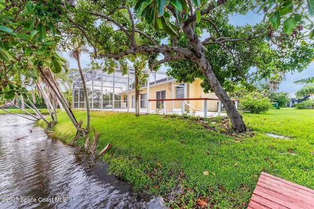 990 Harbor Pines Dr, Merritt Island, FL 32952 - view of grassy yard with a water view and glass enclosure